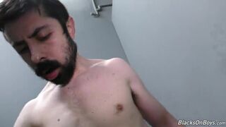 Bearded white man sucking and fucking a black cock at a gloryhole